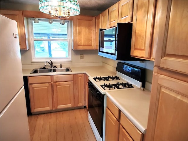 620 Gross St, Conway, PA 15027 - kitchen with range with gas stovetop, freestanding refrigerator, a sink, light wood-style floors, and light countertops