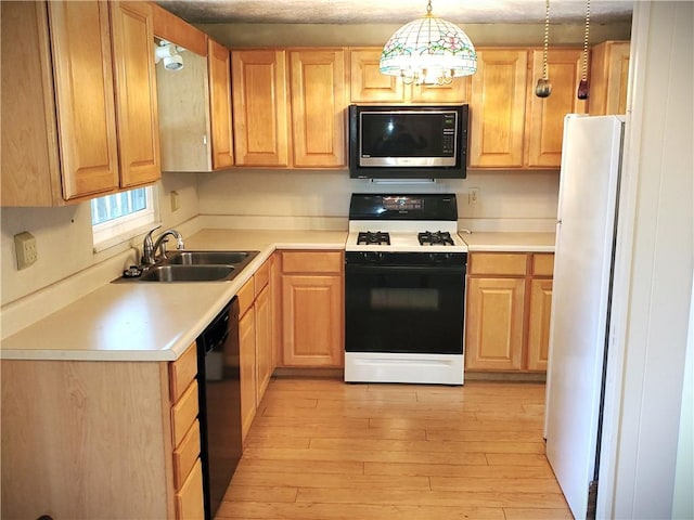 620 Gross St, Conway, PA 15027 - kitchen featuring range with gas stovetop, freestanding refrigerator, a sink, light brown cabinets, and light wood-style flooring