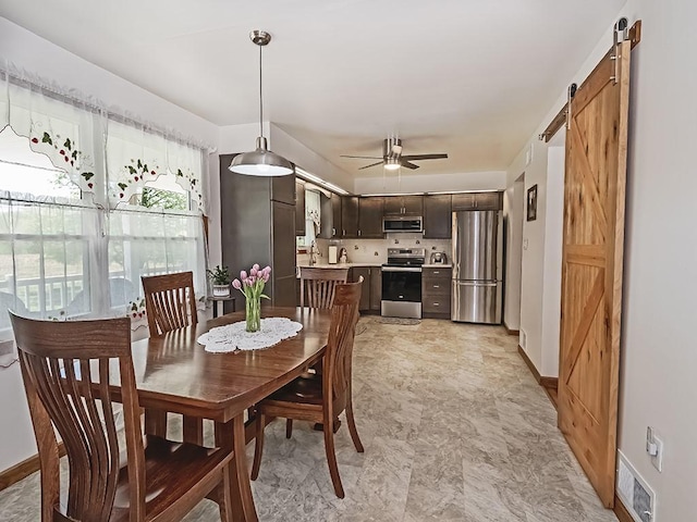 349 Marwood Rd, Winfield Twp, PA 16023 - dining room with a barn door, baseboards, and a ceiling fan