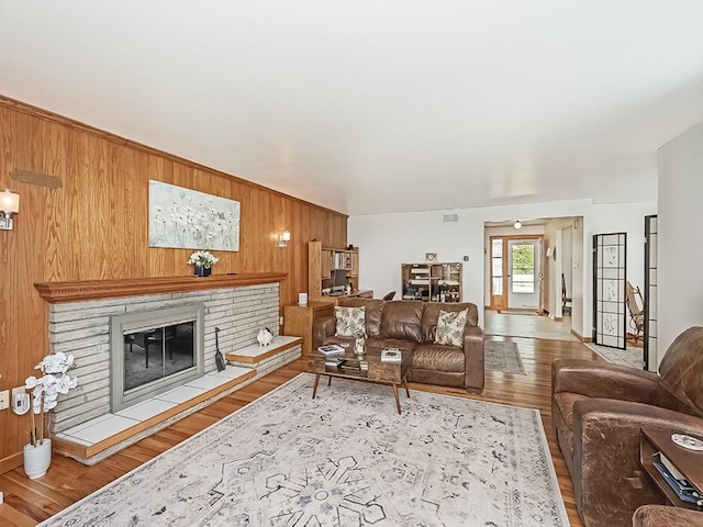 349 Marwood Rd, Winfield Twp, PA 16023 - living area with wooden walls, wood finished floors, and a glass covered fireplace