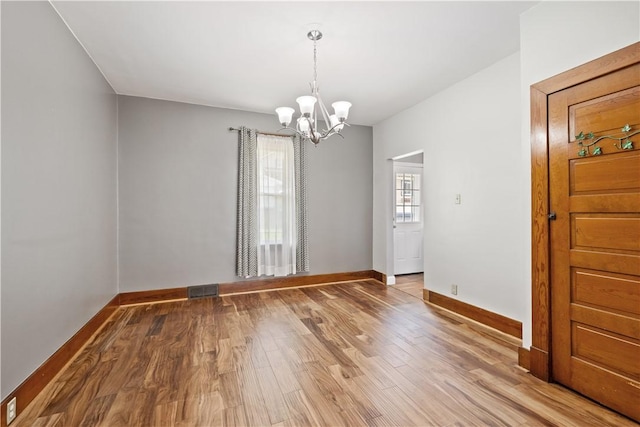 716 Center Ave N, Charleroi, PA 15022 - unfurnished dining area with a chandelier, wood finished floors, and baseboards