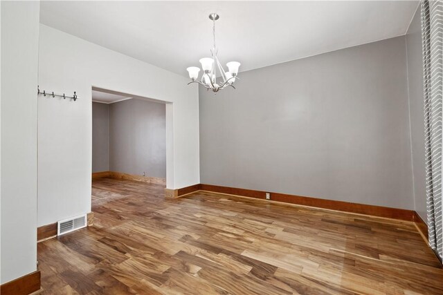 716 Center Ave N, Charleroi, PA 15022 - unfurnished room with a chandelier, wood finished floors, and baseboards