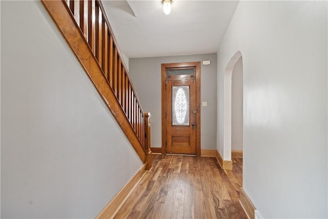 716 Center Ave N, Charleroi, PA 15022 - foyer entrance featuring arched walkways, light wood-style floors, baseboards, and stairway