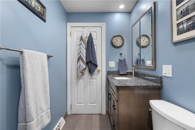 bathroom with vanity, toilet, and tile patterned floors