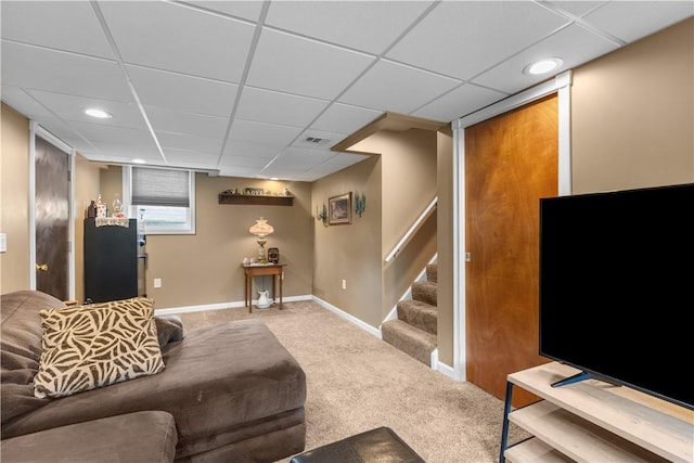 carpeted living area with stairs, a drop ceiling, baseboards, and recessed lighting