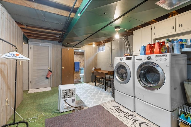 washroom featuring washer and dryer and cabinet space