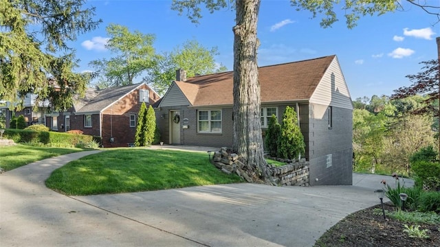 172 Orchard Dr, Pleasant Hills, PA 15236 - view of front of home with brick siding, a front yard, concrete driveway, and a chimney