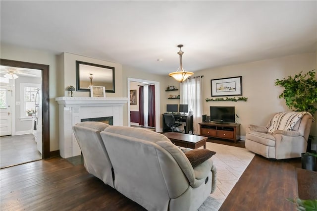 363 Highland Ave, West View, PA 15229 - living area featuring a fireplace, wood finished floors, ceiling fan, baseboards, and a desk