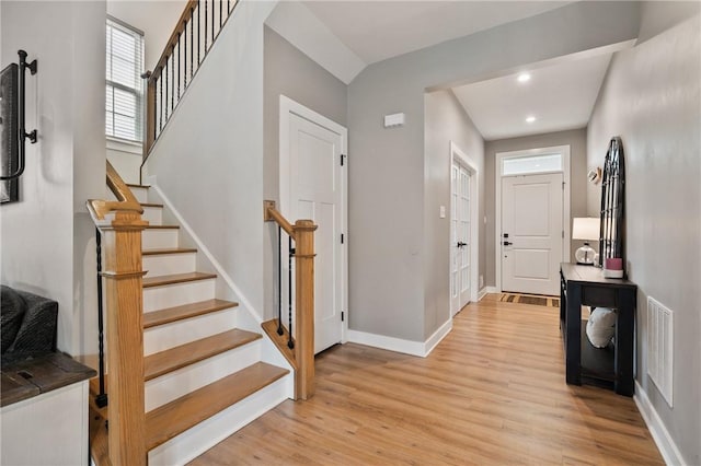 entryway featuring light wood-type flooring, stairway, recessed lighting, and baseboards