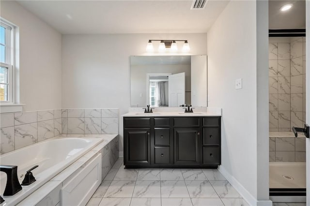 full bathroom with marble look tiles, a garden tub, double vanity, baseboards, and a shower stall