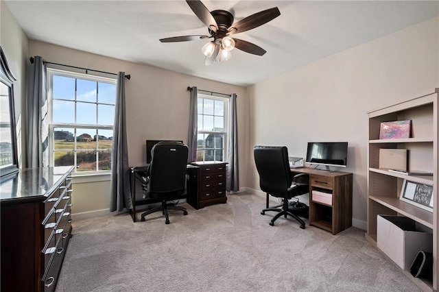 home office featuring ceiling fan, light colored carpet, and baseboards