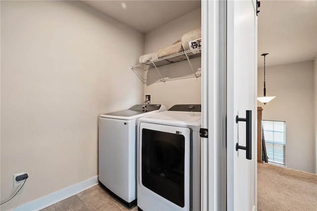 laundry room featuring washer and clothes dryer and baseboards