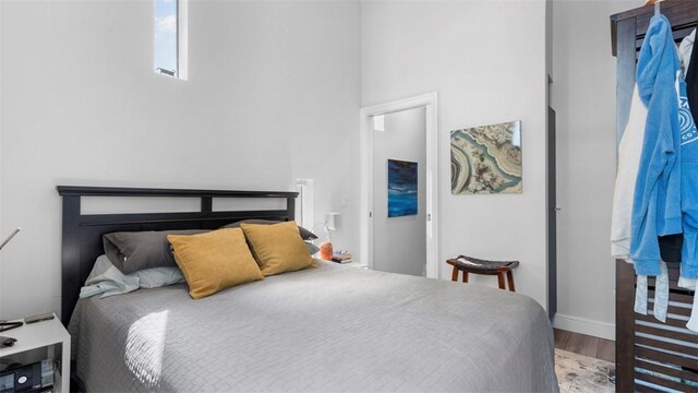 2132 Sarah St Unit 201, South Side, PA 15203 - bedroom featuring wood finished floors, baseboards, and a towering ceiling