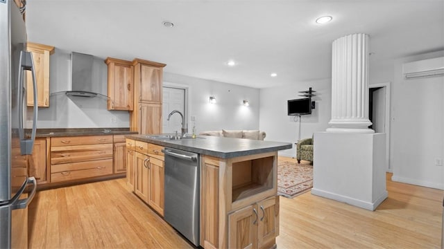 2132 Sarah St Unit 201, South Side, PA 15203 - kitchen with wall chimney exhaust hood, appliances with stainless steel finishes, a sink, dark countertops, and light wood-type flooring