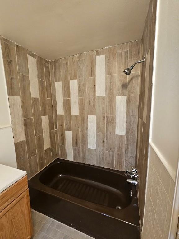 full bathroom featuring tile walls, shower / tub combination, and vanity