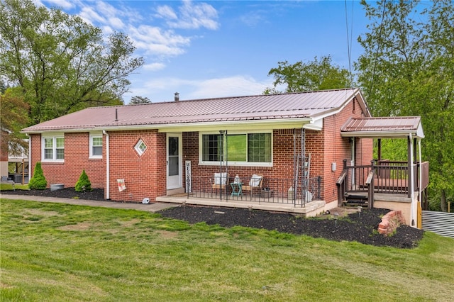 ranch-style house with brick siding, a front yard, and metal roof