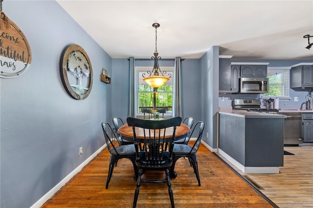 dining area featuring wood finished floors and baseboards