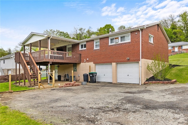 back of property with an attached garage, a deck, driveway, stairs, and brick siding