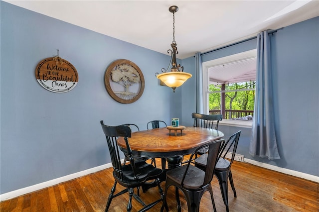 dining area featuring baseboards and wood finished floors
