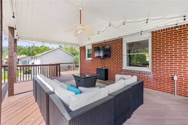 wooden deck featuring outdoor lounge area and ceiling fan