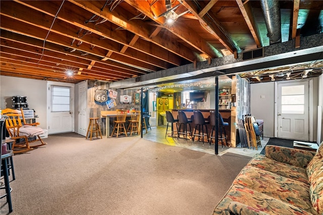 basement featuring a bar and carpet