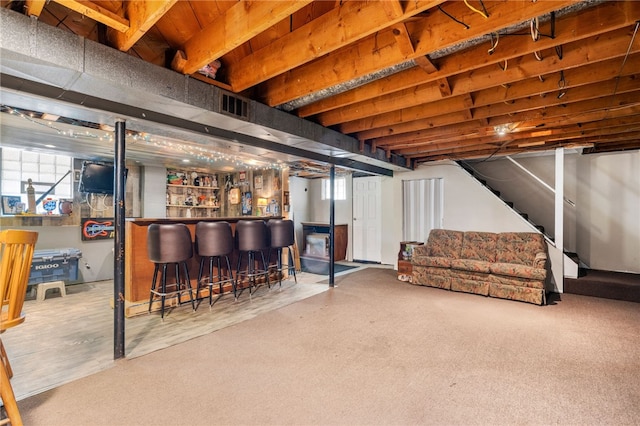 below grade area with a bar and stairs