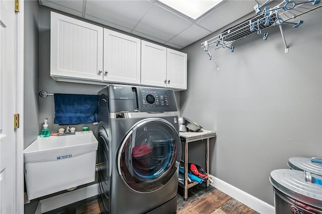 9935 Greiser Rd, Conneaut Lake Cra, PA 16316 - laundry area featuring washer / dryer, dark wood-style flooring, cabinet space, and baseboards