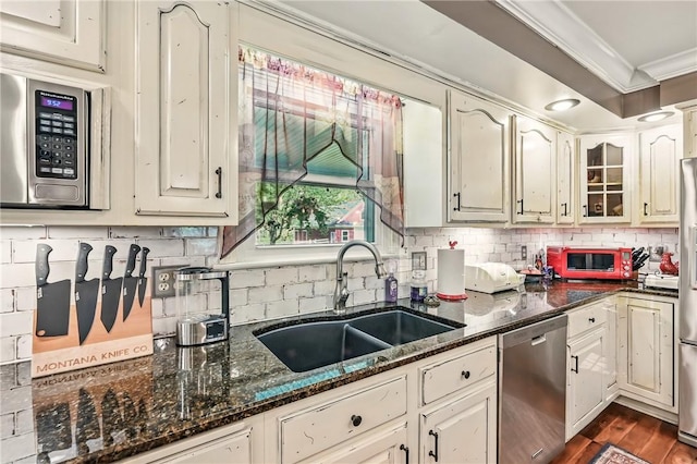 9935 Greiser Rd, Conneaut Lake Cra, PA 16316 - kitchen with stainless steel appliances, a sink, ornamental molding, tasteful backsplash, and dark stone counters