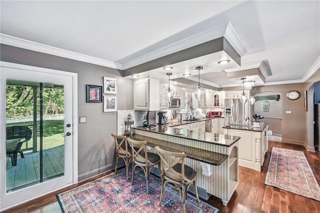 9935 Greiser Rd, Conneaut Lake Cra, PA 16316 - kitchen with a sink, crown molding, appliances with stainless steel finishes, a peninsula, and dark wood finished floors