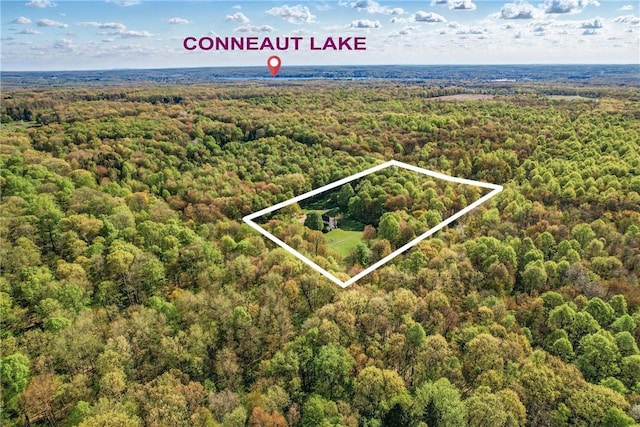 9935 Greiser Rd, Conneaut Lake Cra, PA 16316 - aerial view of property and surrounding area featuring a forest and property parcel outlined