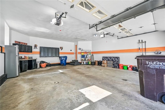 9935 Greiser Rd, Conneaut Lake Cra, PA 16316 - garage with freestanding refrigerator and a garage door opener