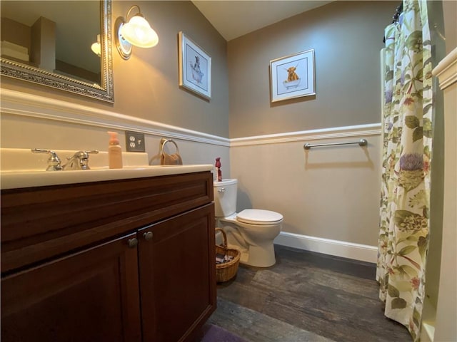 9935 Greiser Rd, Conneaut Lake Cra, PA 16316 - full bathroom featuring wood finished floors, toilet, vanity, baseboards, and a shower with shower curtain