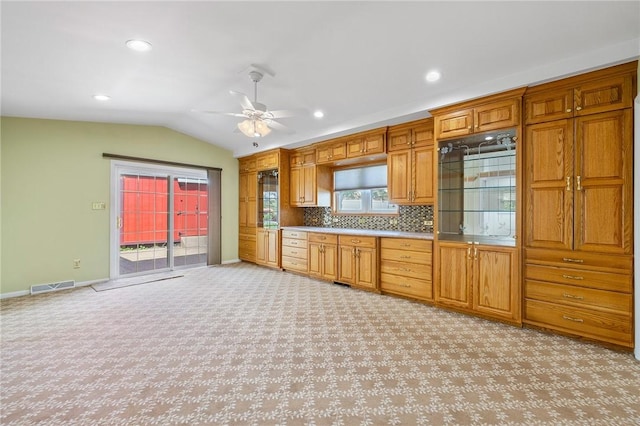 118 Tangelo Dr, Jefferson Hills, PA 15025 - kitchen featuring light carpet, lofted ceiling, a ceiling fan, baseboards, and brown cabinets