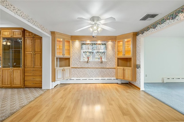 118 Tangelo Dr, Jefferson Hills, PA 15025 - empty room with baseboard heating, wallpapered walls, a ceiling fan, light wood-type flooring, and light colored carpet