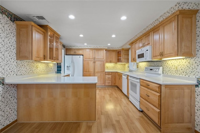 118 Tangelo Dr, Jefferson Hills, PA 15025 - kitchen featuring white appliances, light wood-style flooring, light countertops, a peninsula, and glass insert cabinets
