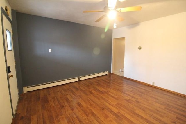 empty room featuring a baseboard radiator, wood finished floors, ceiling fan, and baseboards