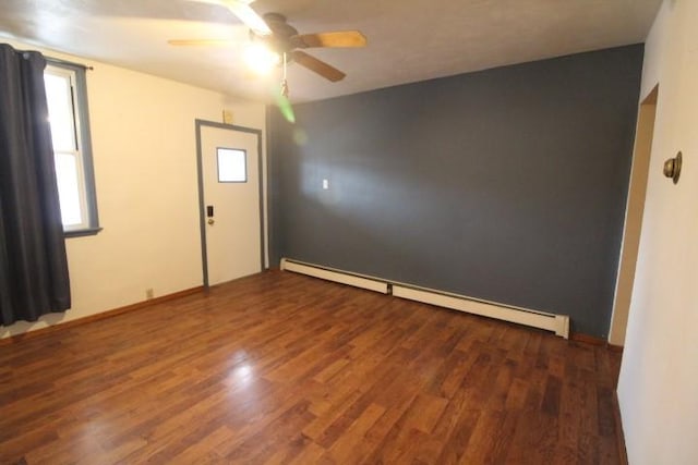 empty room with a baseboard heating unit, wood finished floors, and a ceiling fan