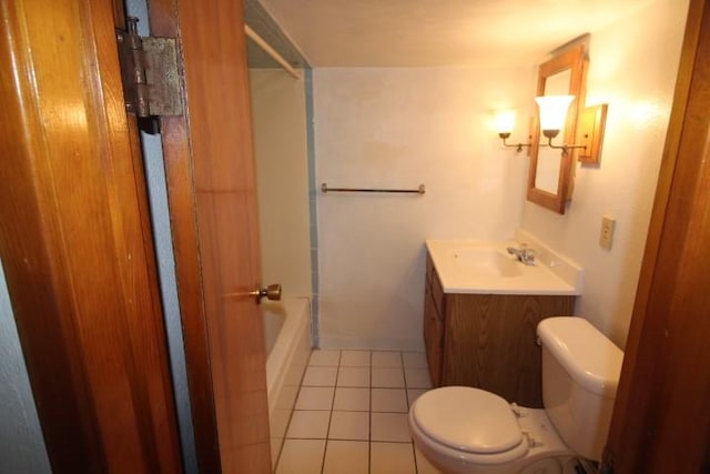 bathroom featuring toilet, tile patterned floors, vanity, and washtub / shower combination