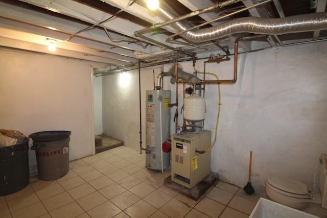 unfinished below grade area with water heater, a heating unit, and light tile patterned floors
