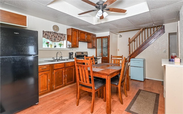 5 Carrie St, Rear, Fineview, PA 15212 - dining room featuring light wood finished floors, ceiling fan, and stairs