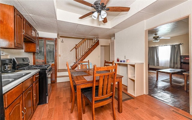 5 Carrie St, Rear, Fineview, PA 15212 - dining room with a ceiling fan, stairs, and light wood-type flooring