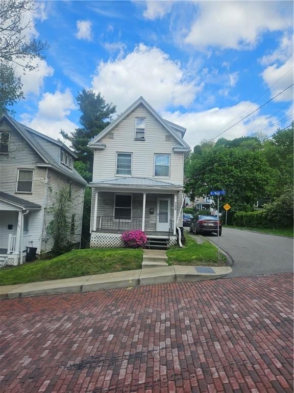 view of front of property with a porch and driveway