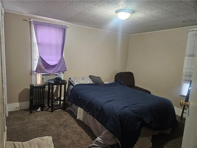 bedroom with carpet flooring, crown molding, radiator heating unit, and cooling unit