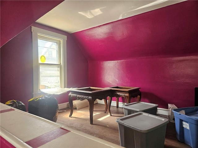 bonus room with lofted ceiling, wood finished floors, and baseboards