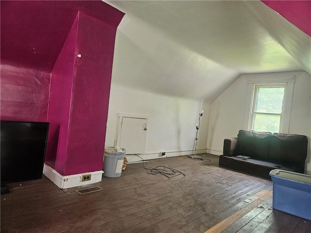 additional living space featuring hardwood / wood-style floors, vaulted ceiling, and baseboards