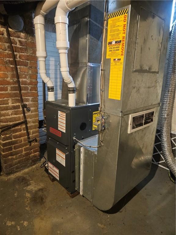 utility room featuring heating unit