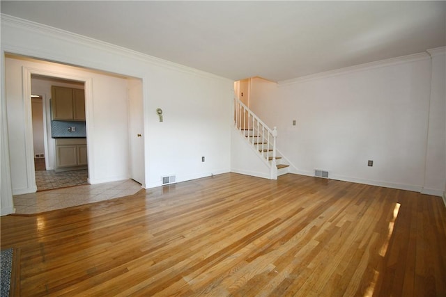 200 Graham St, Sewickley, PA 15143 - unfurnished living room with stairway, light wood-style floors, crown molding, and baseboards