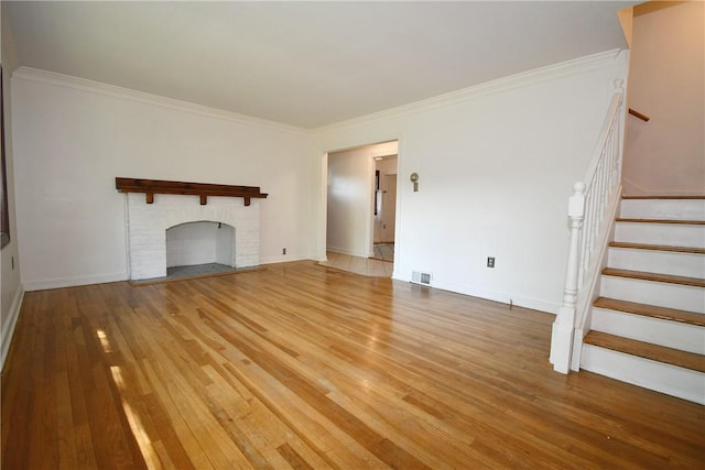 200 Graham St, Sewickley, PA 15143 - unfurnished living room with light wood finished floors, stairway, crown molding, and baseboards