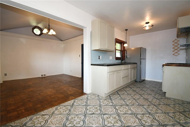 200 Graham St, Sewickley, PA 15143 - kitchen featuring freestanding refrigerator, a chandelier, dark countertops, white cabinets, and lofted ceiling