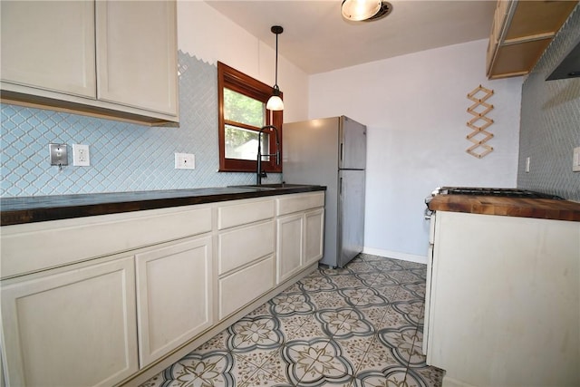 200 Graham St, Sewickley, PA 15143 - kitchen featuring freestanding refrigerator, decorative backsplash, a sink, butcher block counters, and decorative light fixtures